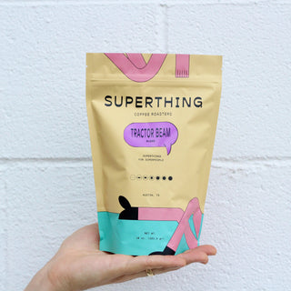 Superthing Tractor Beam coffee bag held in a hand